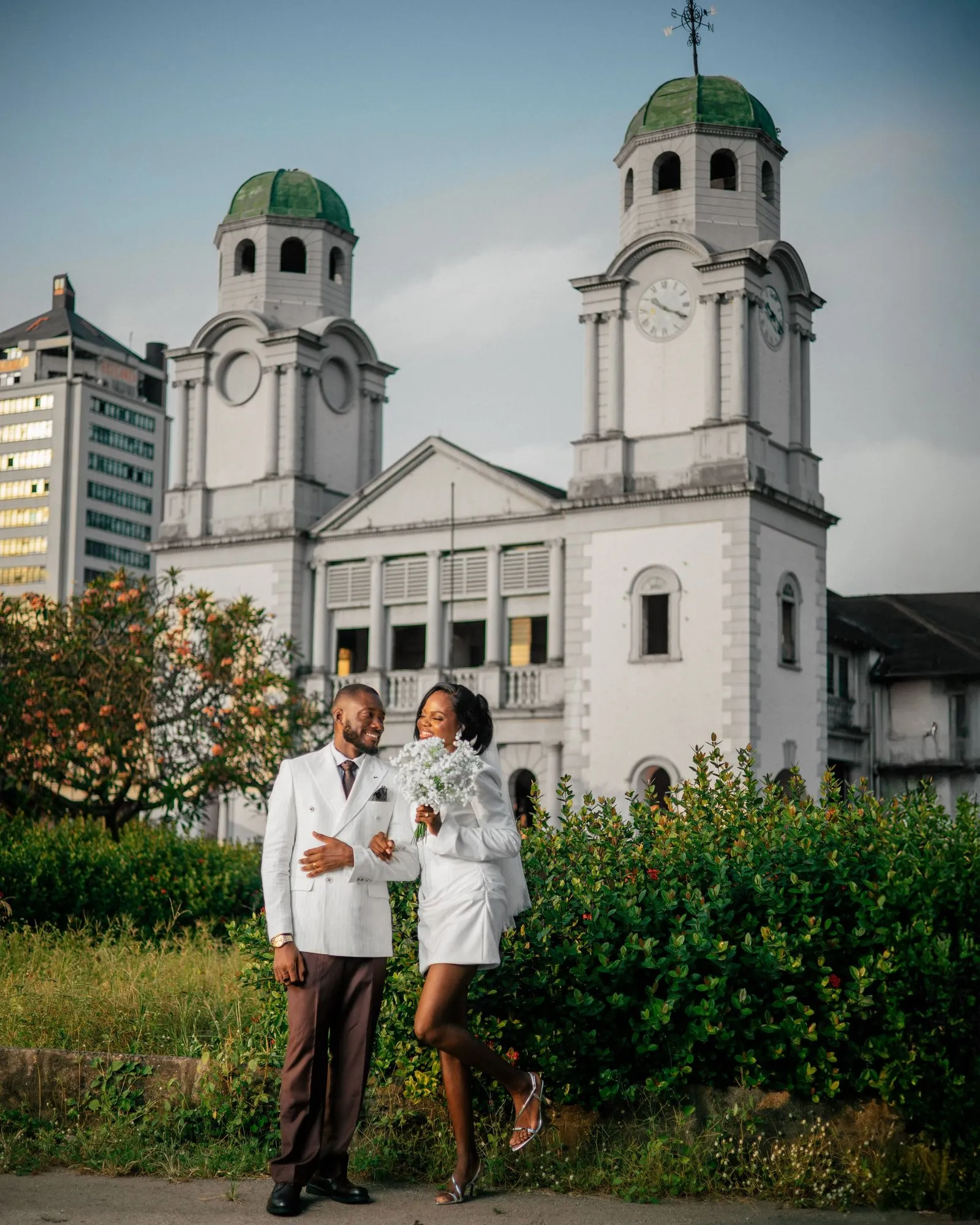 Couple walking hand in hand on the cathedral lawn
