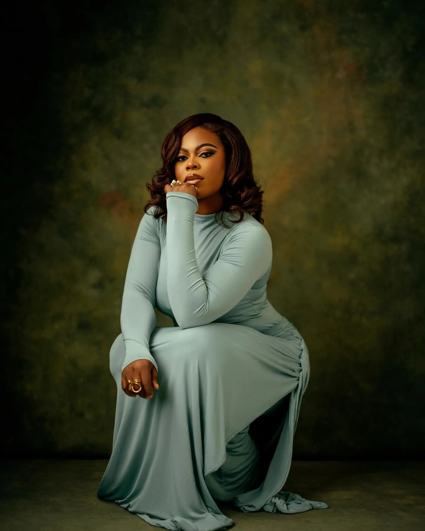 Woman kneeling in the sage dress