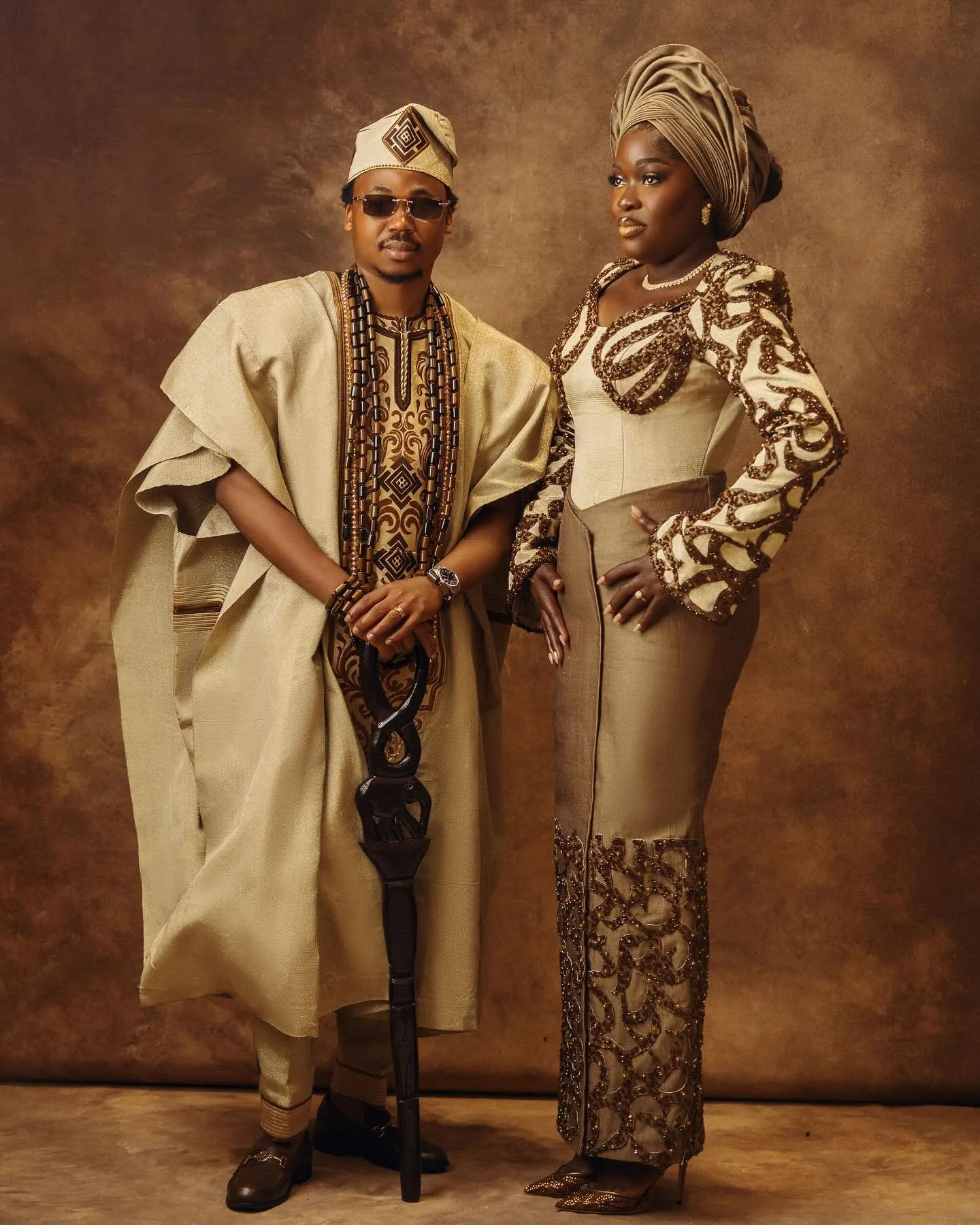 Couple full length, groom adjusting his agbada