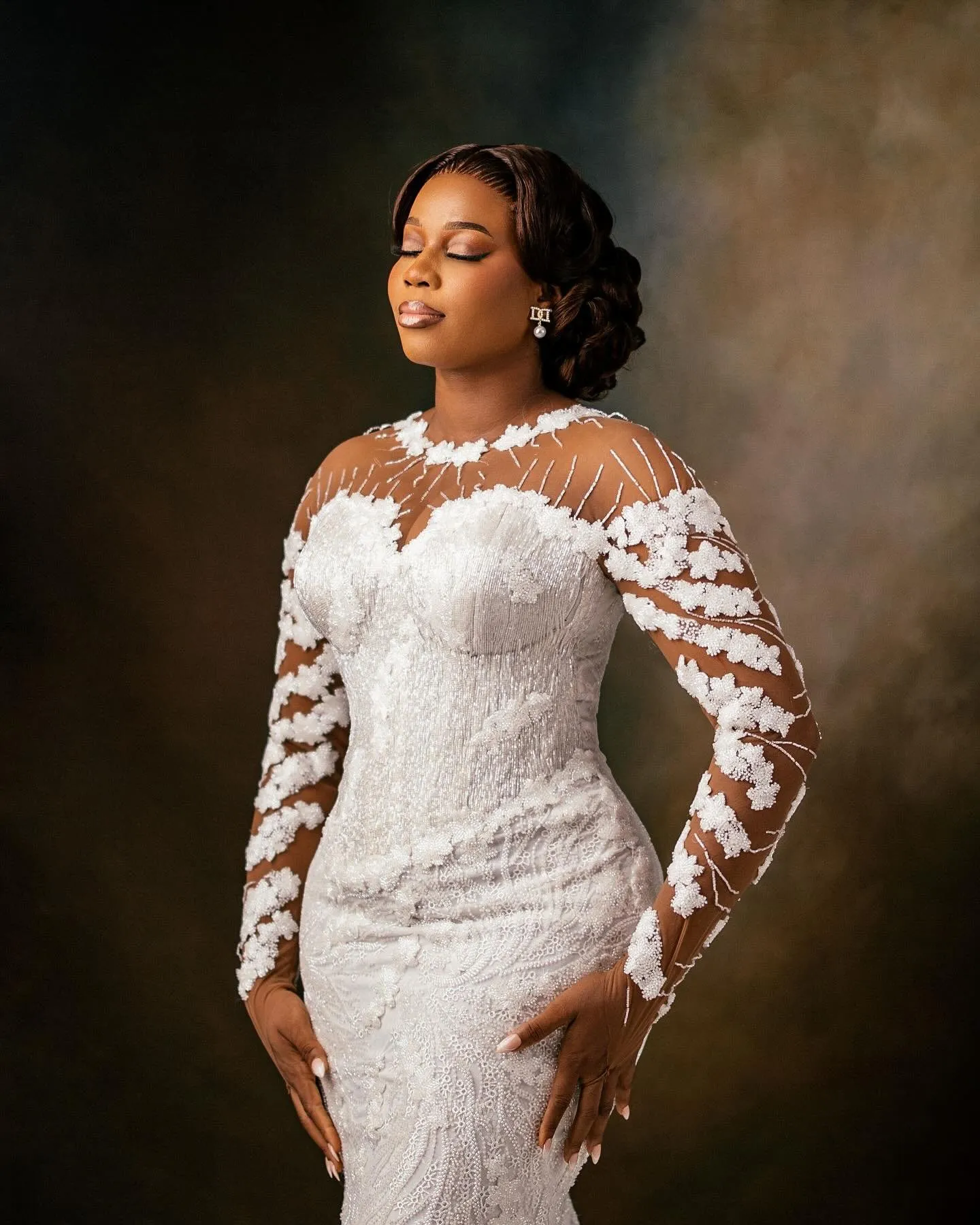 Bride in a lace gown with sheer embroidered sleeves
