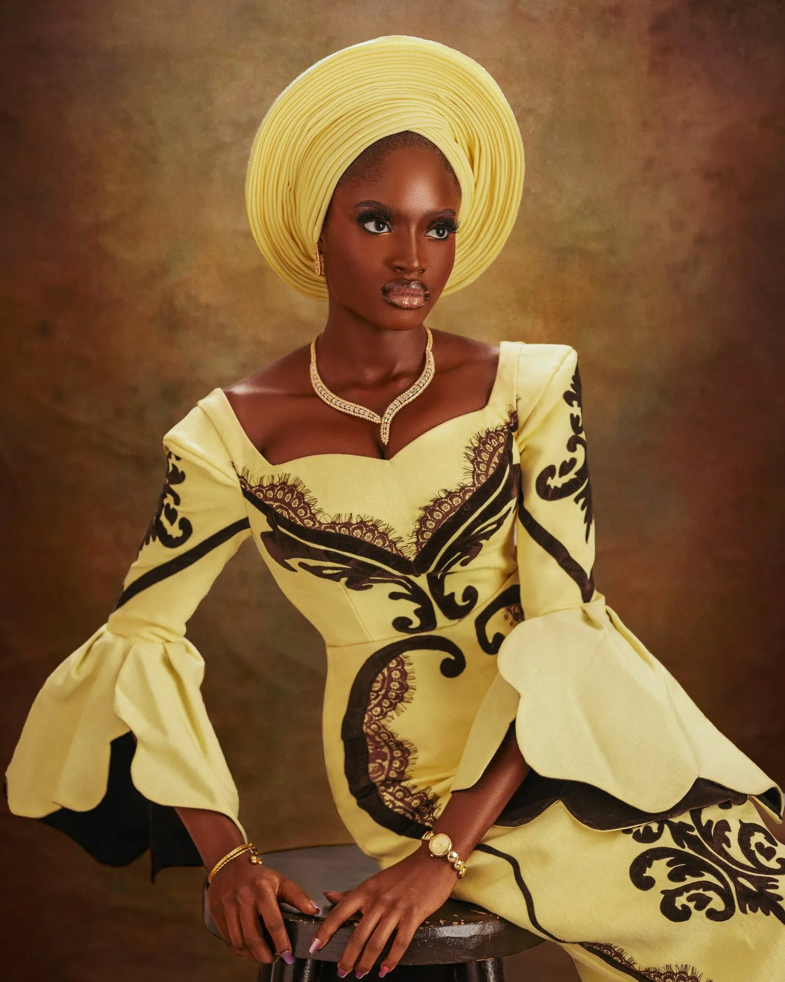 Bride seated with her flared sleeves spread wide