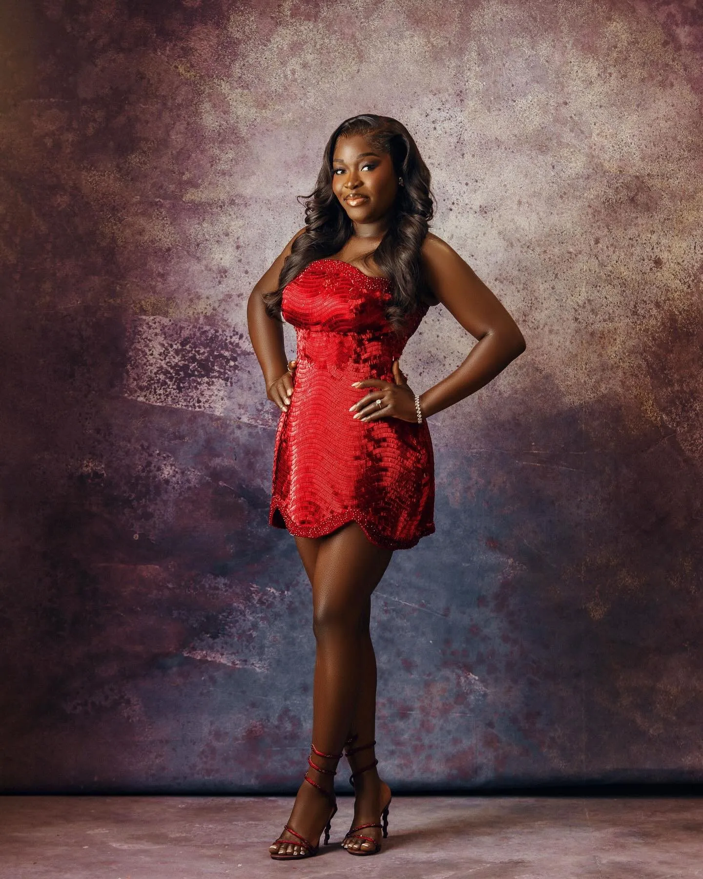 Bride standing in a red sequinned mini dress