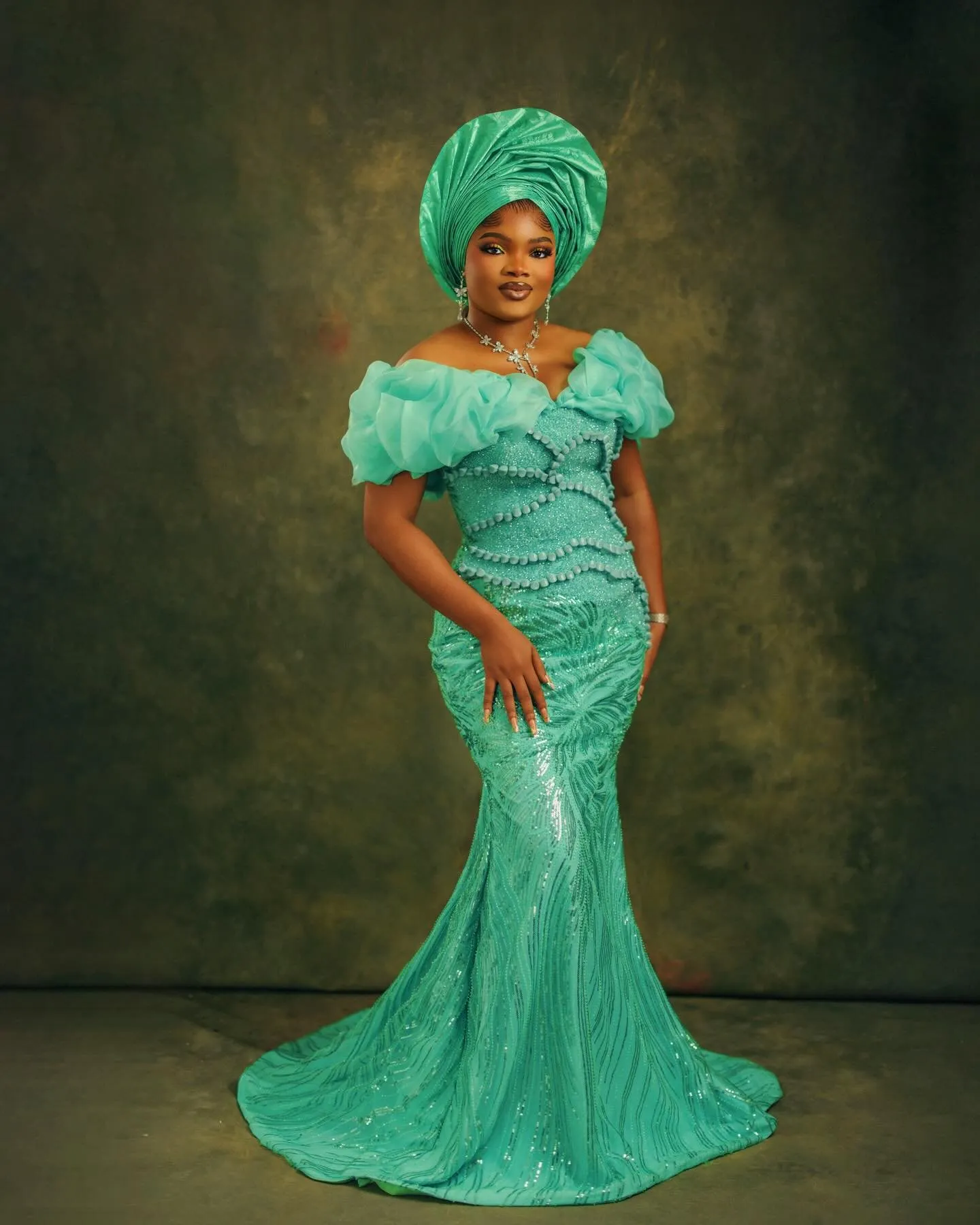 Full length in jade against the painted olive backdrop