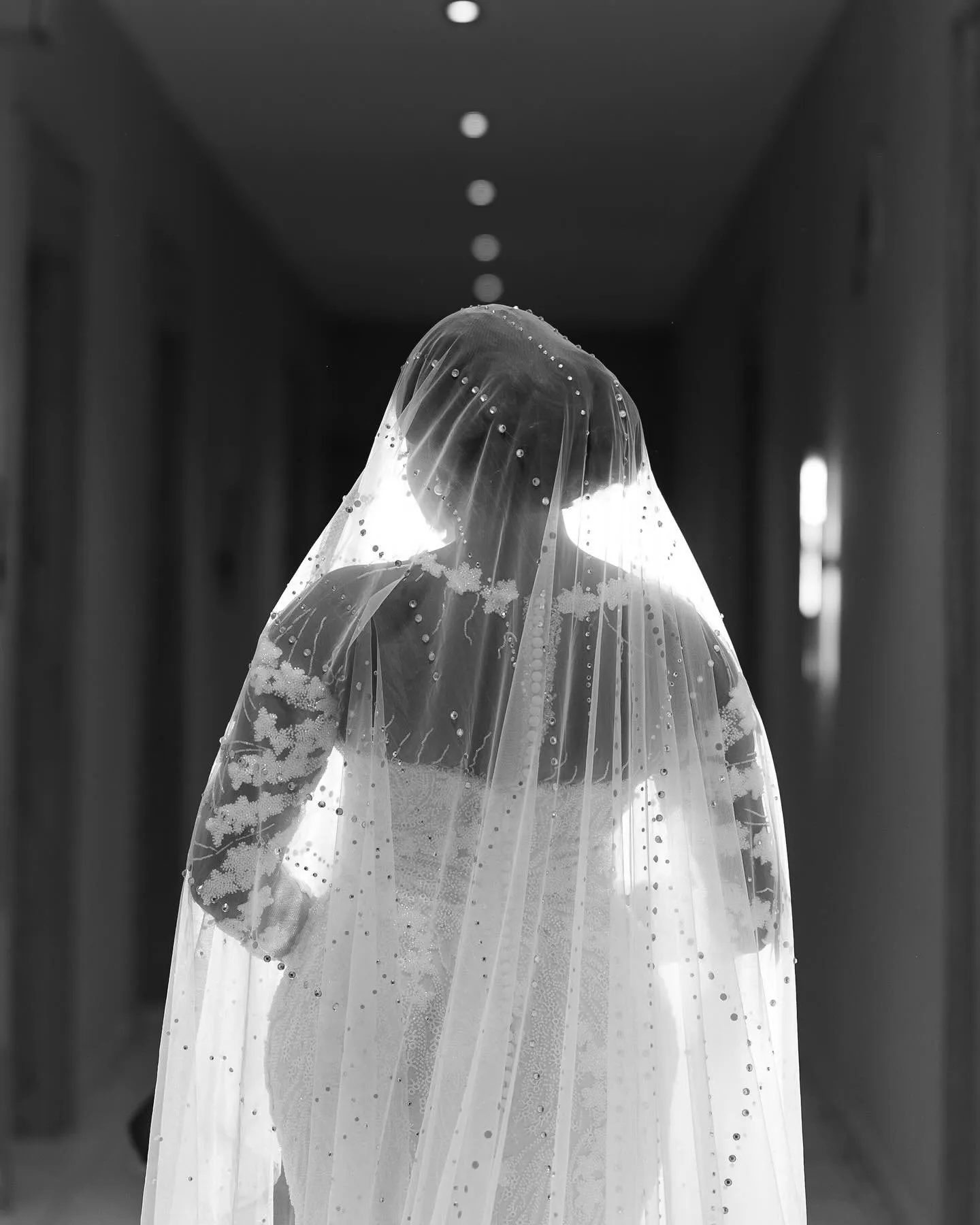 Black-and-white close-up of the bride under her veil