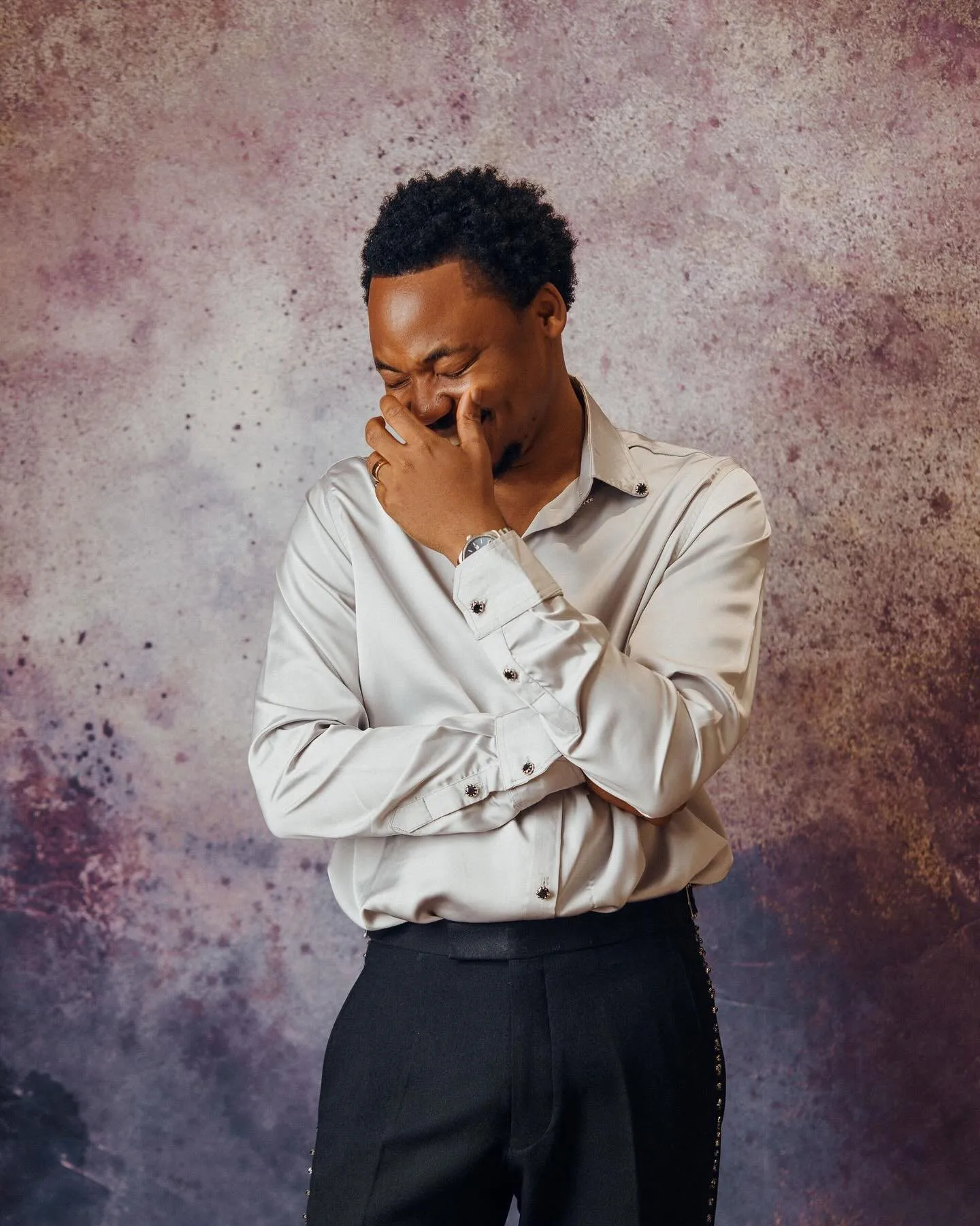 Groom laughing in a white shirt